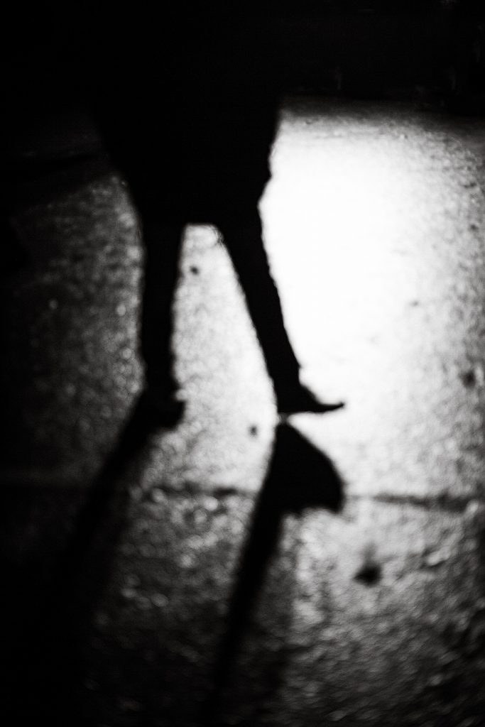 Feet of a man stepping in a flood light